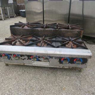 Natural gas countertop 6 burner range, dimensions 36x27x16, used condition with visible wear. Working when removed.