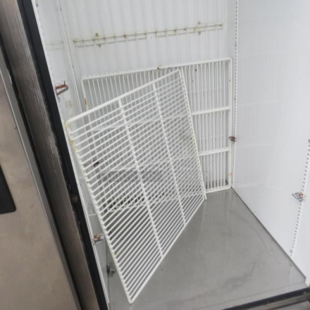 True T-49DT refrigerator/freezer with six racks, stainless steel exterior, on casters. Dimensions: 54x29.5x83 inches.