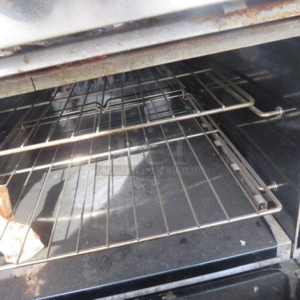 Southbend S60DD natural gas range with 10 burners, stainless steel over shelf, 61x34x66.5 inches, metal racks shown.