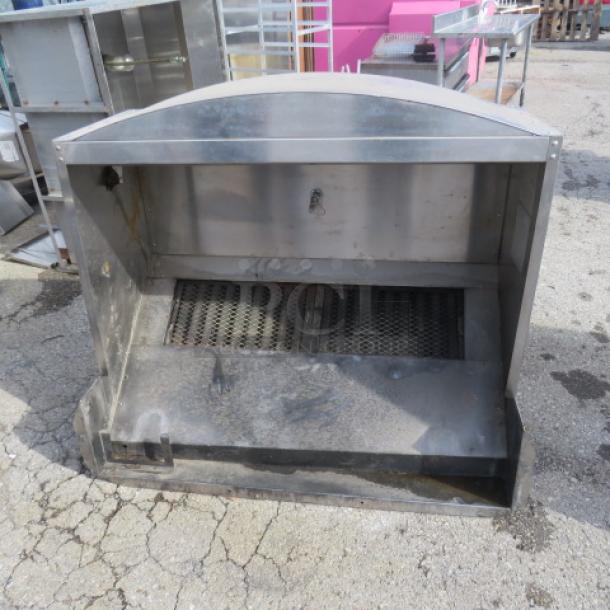 Stainless steel hood system, used condition, features grease traps, designed for commercial kitchen ventilation.