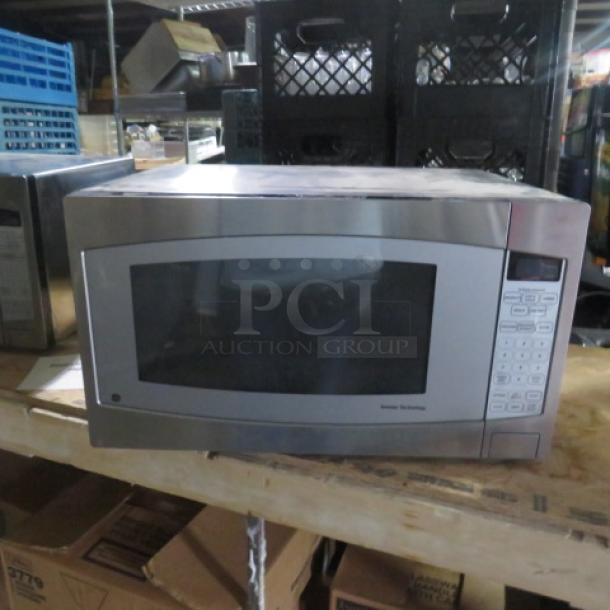 GE Inverter Tech Microwave, Model JES2251SJ03, stainless steel finish, keypad controls, 24x18x14 inches, good condition.