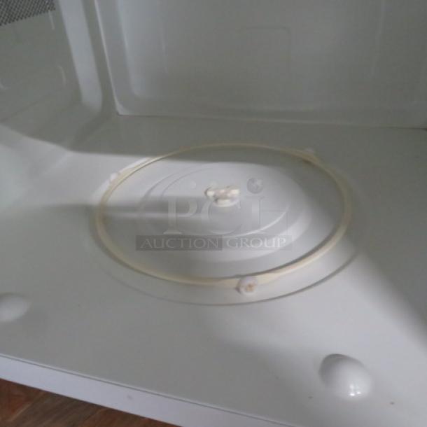 GE Inverter Tech Microwave, Model JES2251SJ03. No glass included. Interior view showing turntable base. Size: 24x18x14 inches.