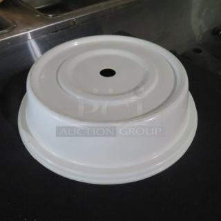 Lot of 25 white poly plate covers, 11-inch diameter, shown in used condition with vent hole for heat retention.