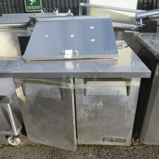 True 2 Door Prep Table on casters, stainless steel, 115 Volt, visible True logo, used condition, sturdy construction.