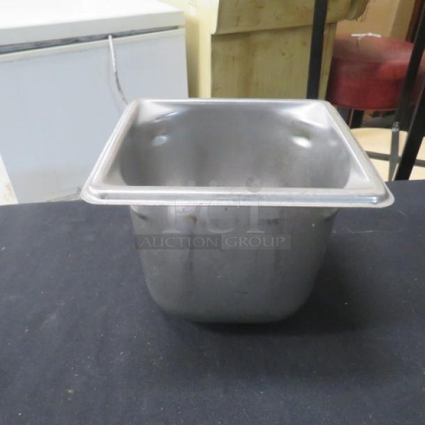 1/6 size, 6-inch deep stainless steel hotel pan. Slight wear. Ideal for food service use.