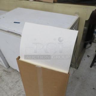 A box of new filter sheets, partially open. Sheets are white, indicating unused condition. Box sealed with tape.