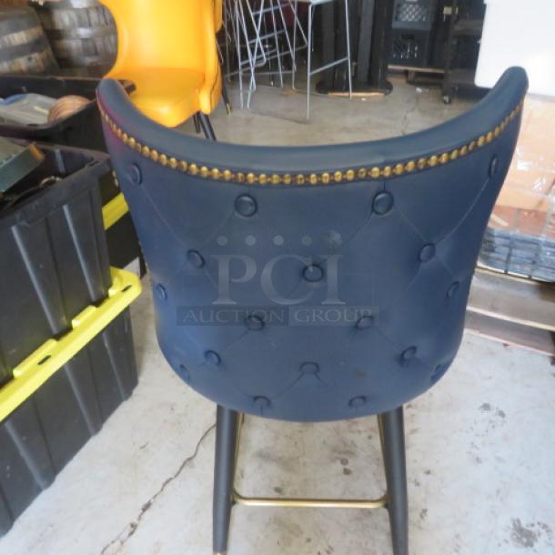 Vintage bar stool with tufted back, footrest, and brass nailhead trim. Good condition. Ideal for retro decor.