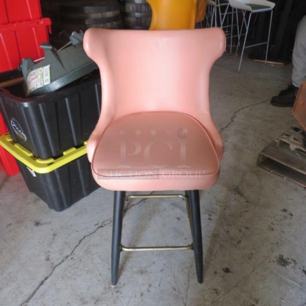 Vintage bar stool with tufted back and footrest, pink seat, and black legs. Good condition. 2XBID.