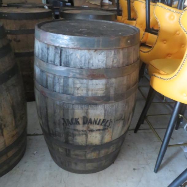 Jack Daniels wooden whiskey barrel, aged patina, visible branding, medium condition, ideal for decor or collection.