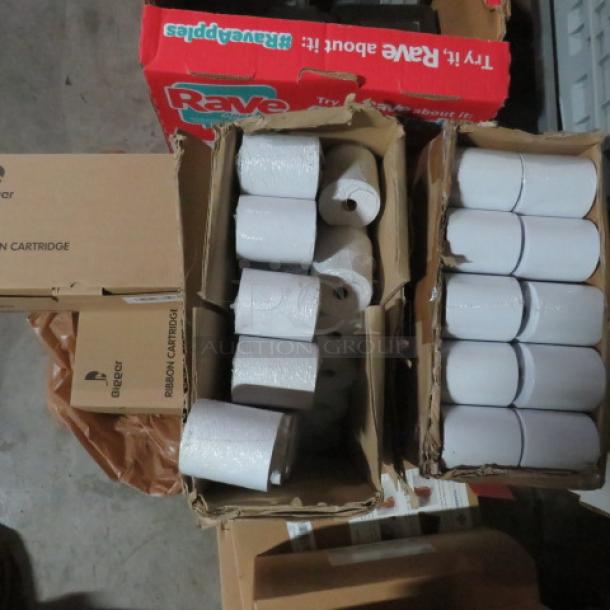 Large lot of thermal roll tape and ribbons in cardboard boxes. Includes numerous rolls, ideal for printers. Boxes labeled "Rave."