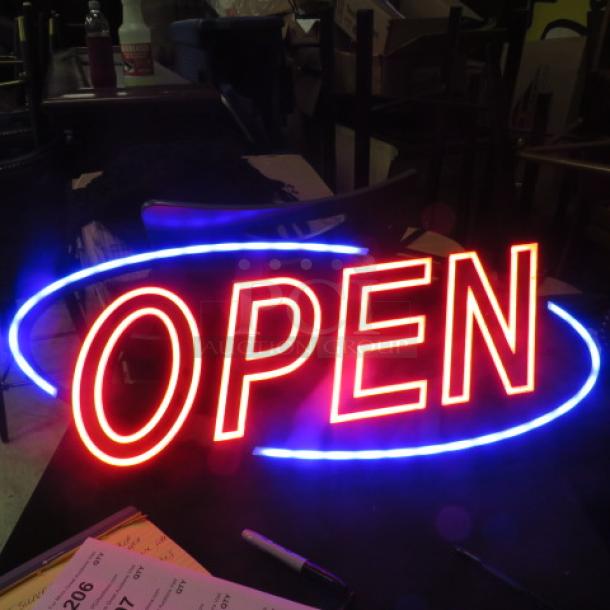 Illuminated LED "Open" sign in red and blue, 31x13 inches, in working condition, ideal for businesses.