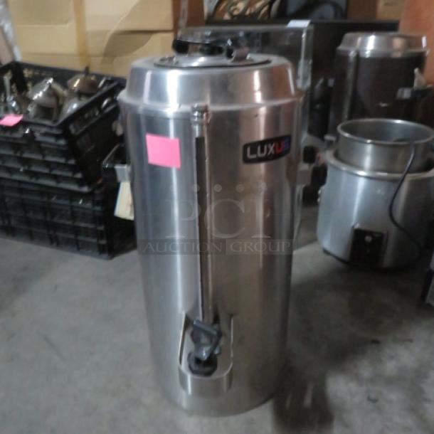 Stainless steel Fetco Luxus TPD-30, 3-gallon hot/cold beverage dispenser, in good condition, with visible Luxus label.