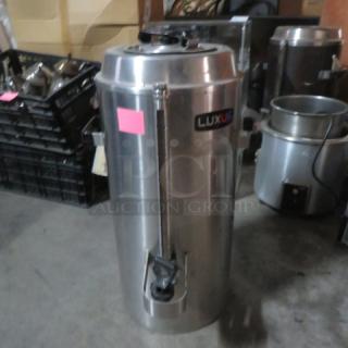Stainless steel Fetco Luxus TPD-30, 3-gallon hot/cold beverage dispenser, in good condition, with visible Luxus label.