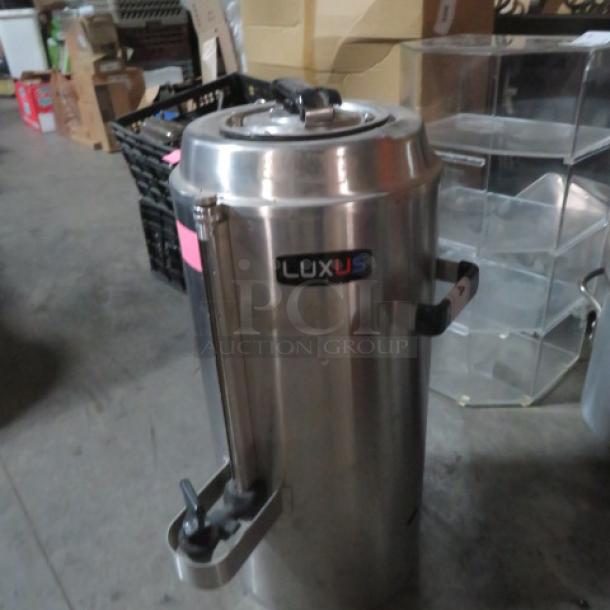 Stainless steel Fetco Luxus 3-gallon beverage dispenser, model TPD-30, featuring hot/cold capability. Excellent condition.