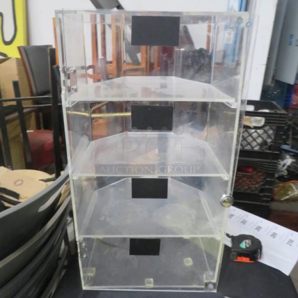 Acrylic pastry/bakery case with 1 door, 4 shelves, 13x12x24.5 inches. Needs pin for top hinge. Clear design, good condition.
