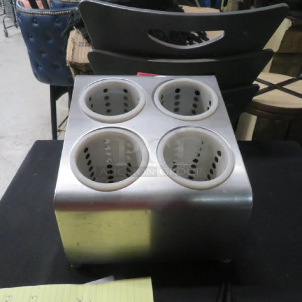 Stainless steel 4-hole flatware holder in good condition, featuring perforated inserts for organizing utensils.