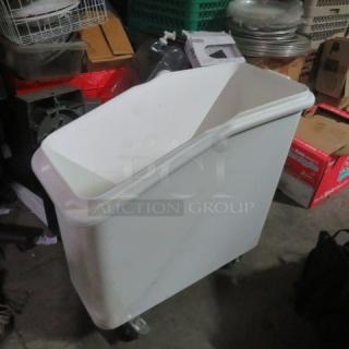 White ingredient bin on casters, no lid, shows signs of use. Ideal for kitchen storage or bulk ingredients.