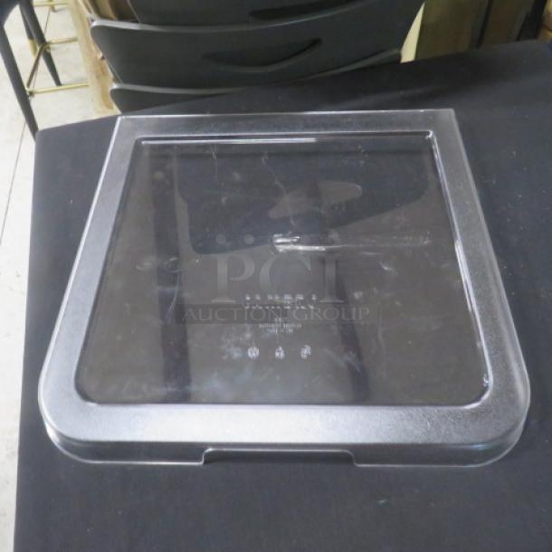 Cambro IBS27 Ingredient Bin Lid, new condition, clear plastic, brand markings visible. Ideal for storing bulk ingredients.