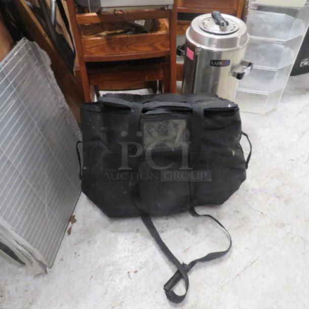 Black One Pro Delivery Bag, spacious with sturdy straps, slightly worn. Ideal for deliveries. No visible tags or markings.