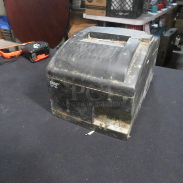 Star SP700 thermal printer, worn condition with visible marks and scratches. Model label: "Star SP700."
