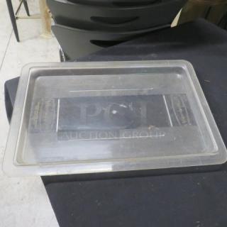 Clear rectangular food storage lid, model 6XBID. Slightly used with minor scuffs, no visible cracks or damage.
