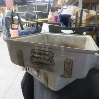 Aluminum roasting pan, 20.5x16.5x5 inches, well-used with riveted handles; visible scratches and wear.