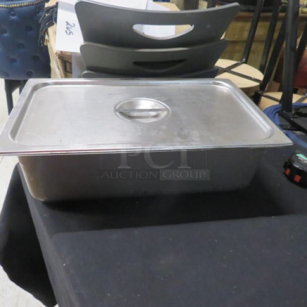 Full-size 6-inch deep hotel pan with lid, stainless steel, used condition, ideal for catering or kitchen use.