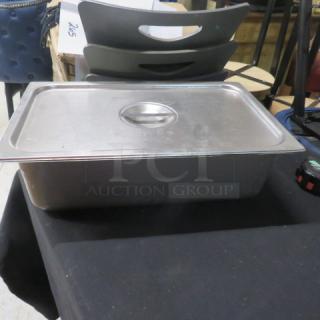Full-size 6-inch deep hotel pan with lid, stainless steel, used condition, ideal for catering or kitchen use.
