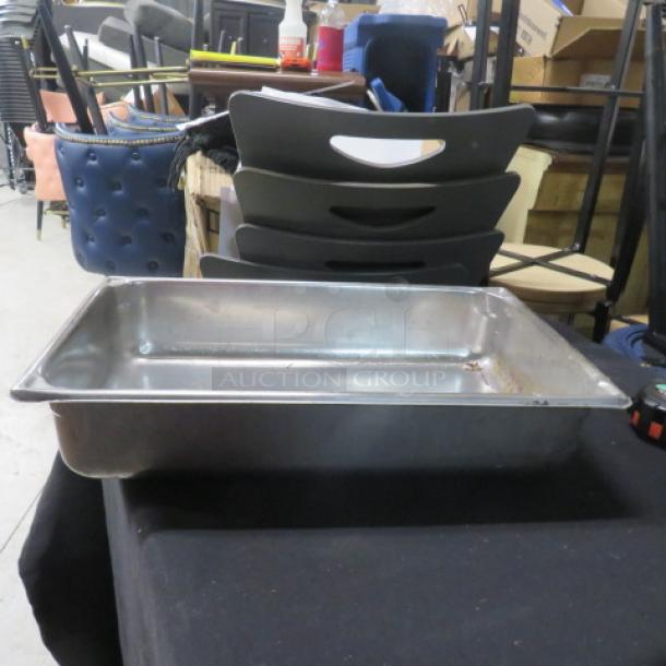 Full size 4-inch deep stainless steel hotel pan, used condition, minor scratches, no visible brand markings.