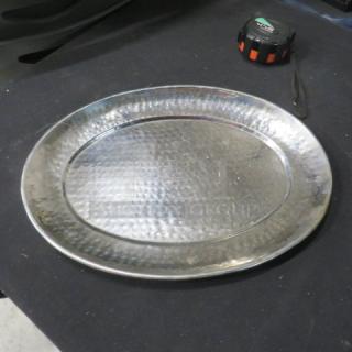 15x11.5-inch hammered stainless steel platter in good condition, reflective surface, oval shape, no visible dents or scratches.