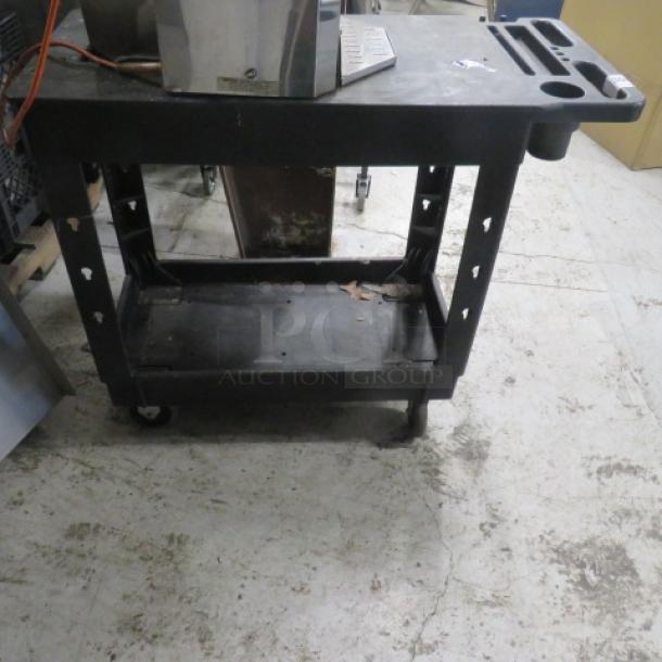 Black Global 2-shelf poly cart on casters with cutout on top shelf, ideal for #302 juicer. Measures 17.5x38.5x32.5 inches.