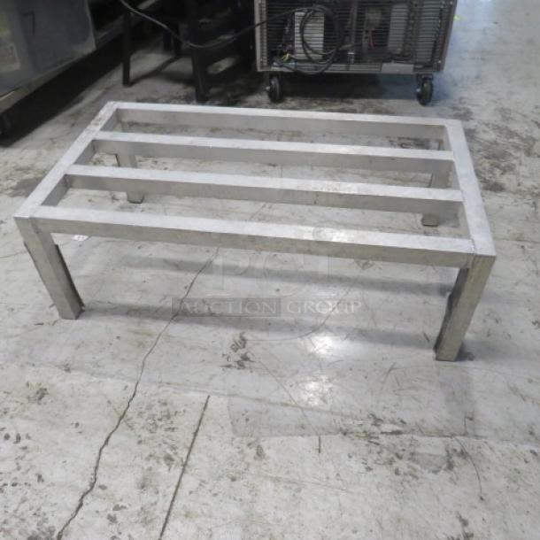 Aluminum dunnage rack, 36x20x12 inches, sturdy frame, used condition, ideal for storage and organization.