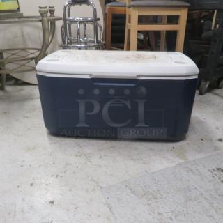 Coleman cooler, blue with white lid, used, moderate wear. Suitable for camping or outdoor activities.