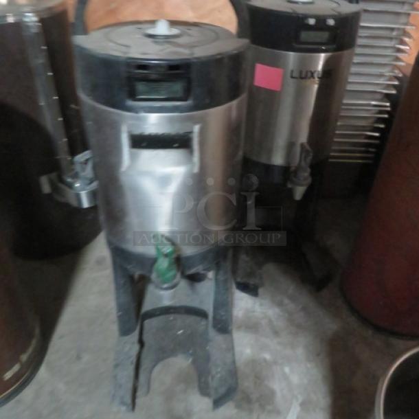 Fetco L3D-15 Luxus 1.5-gallon beverage dispenser on stand, stainless steel, used condition, visible branding.