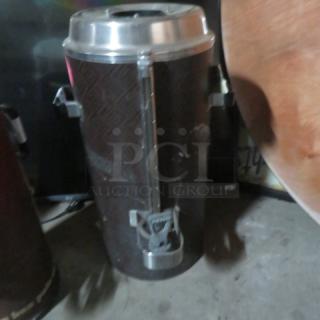 Fetco Luxus 3-gallon beverage dispenser, model TDP-15. Missing lid, used condition, visible wear and scratches. No visible tags or labels.