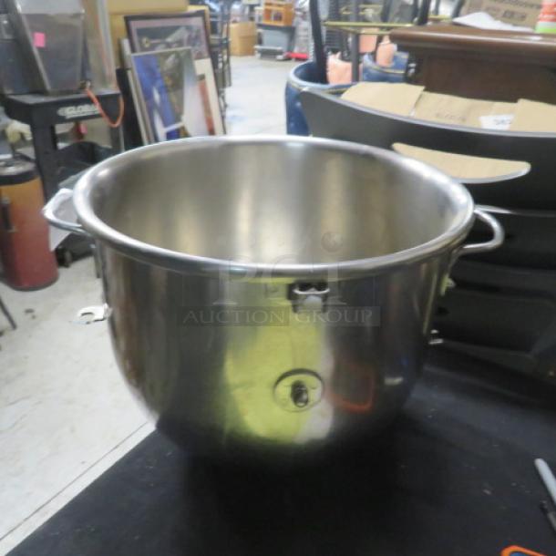 Stainless steel mixing bowl, large size, with sturdy handles. Slightly used condition, suitable for kitchen use.