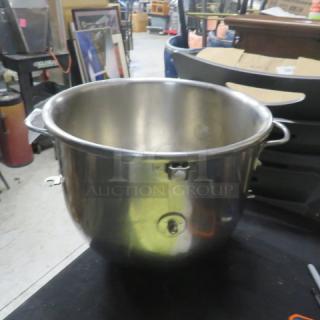 Stainless steel mixing bowl, large size, with sturdy handles. Slightly used condition, suitable for kitchen use.