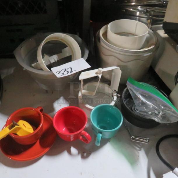 Assorted kitchenware lot with red and turquoise cups, white plastic rings, and a bag with small items. Label marked "332".