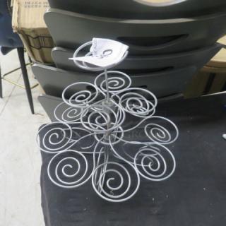 Metal cupcake holder with spiral design, fits multiple cupcakes, in good condition. Includes a tag with auction details.