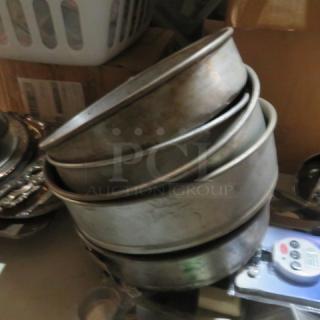 Lot of assorted bake pans, stacked. Visible wear, ideal for baking. No visible labels or markings.