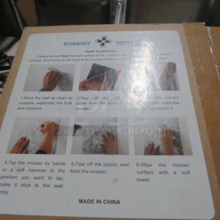 Box of assorted mosaic wall tiles with installation instructions. Marked "Xuaniny Mosaic, Made in China."