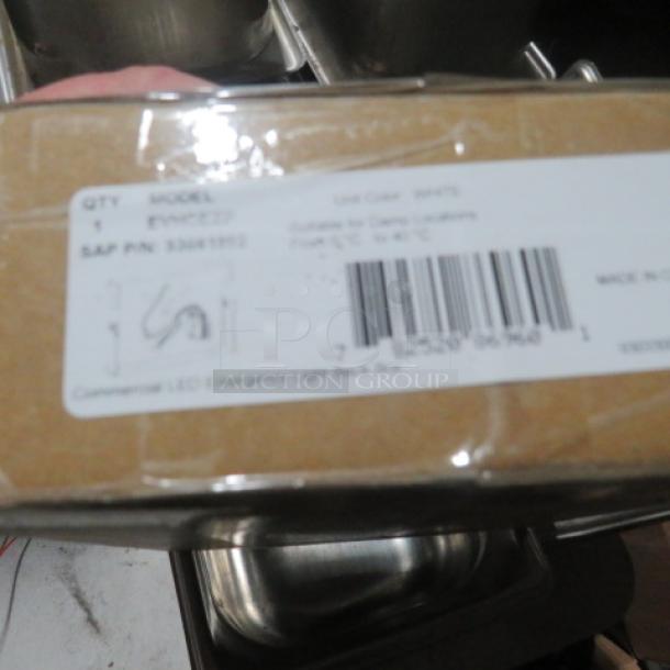 Boxed Dualite LED Emergency Light Back Box, Model #EVHCEZP. Label includes SAP P/N 830489952 and barcode. New condition.