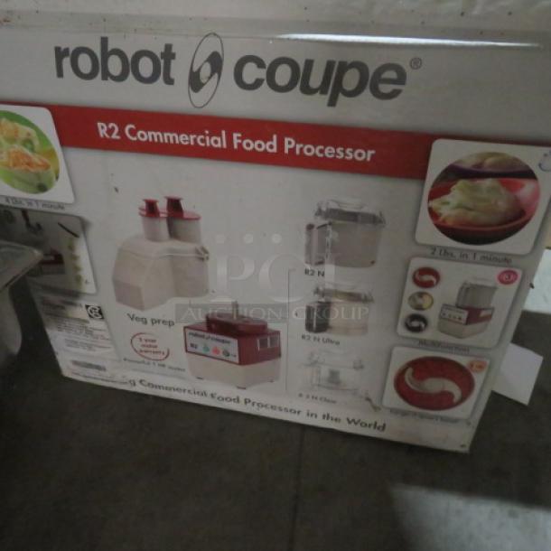 Robot Coupe R2 Commercial Food Processor in box, new condition. Model R2, price $1710. Features and accessories illustrated.