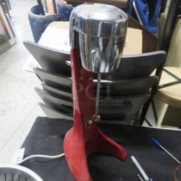 Waring Pro Mixer with stainless steel cup, model #12DM19, in used condition. 120 Volt, red base with chrome top.