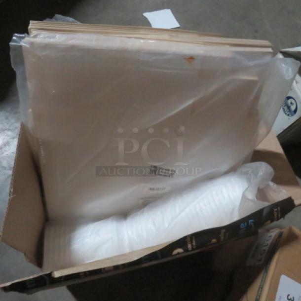 Box of assorted to-go items, including white plastic containers and paper sheets. Items appear new in original packaging.