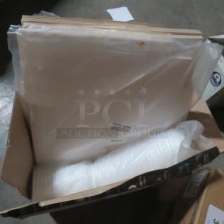 Box of assorted to-go items, including white plastic containers and paper sheets. Items appear new in original packaging.