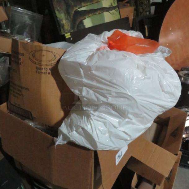 One lot of to-go items in a cardboard box, includes a large white plastic bag with an orange handle, indicating bulk packaging.
