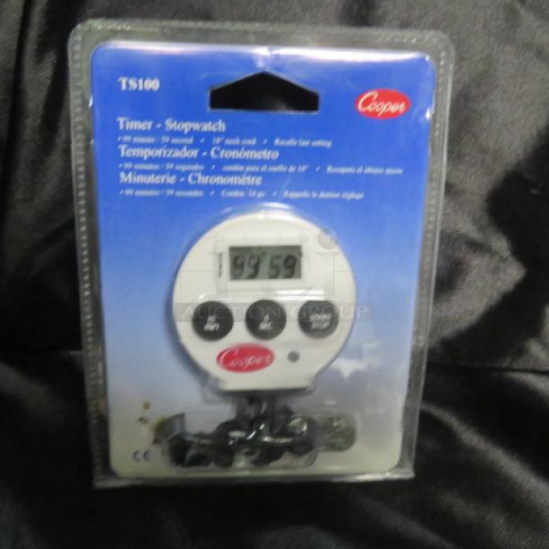 Cooper Timer Model TS100, new in packaging. Features stopwatch, countdown, black buttons, and digital display.