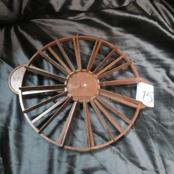 Brown plastic pie cutter with multiple blades, circular design, label marked "75." Appears in good condition.