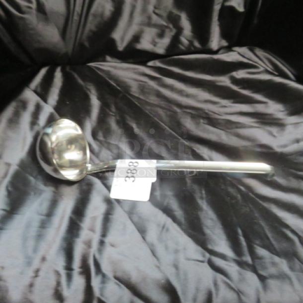 New 5.4oz stainless steel ladle with a sleek finish, pristine condition. Features a long handle and smooth, round bowl.